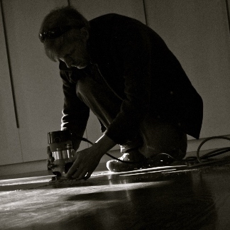 man with router on floor